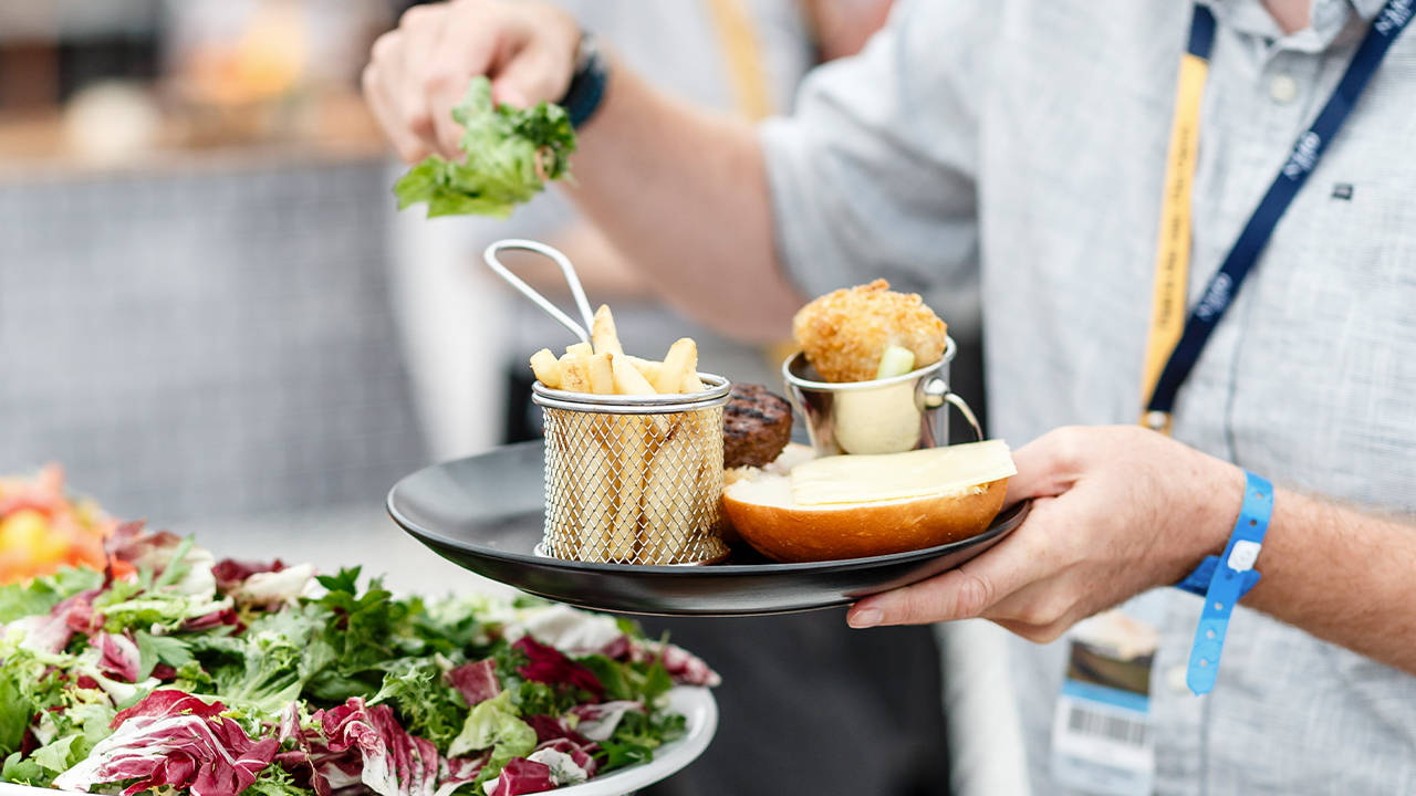 Chefs serving a variety of hearty classics from a central station during lunch